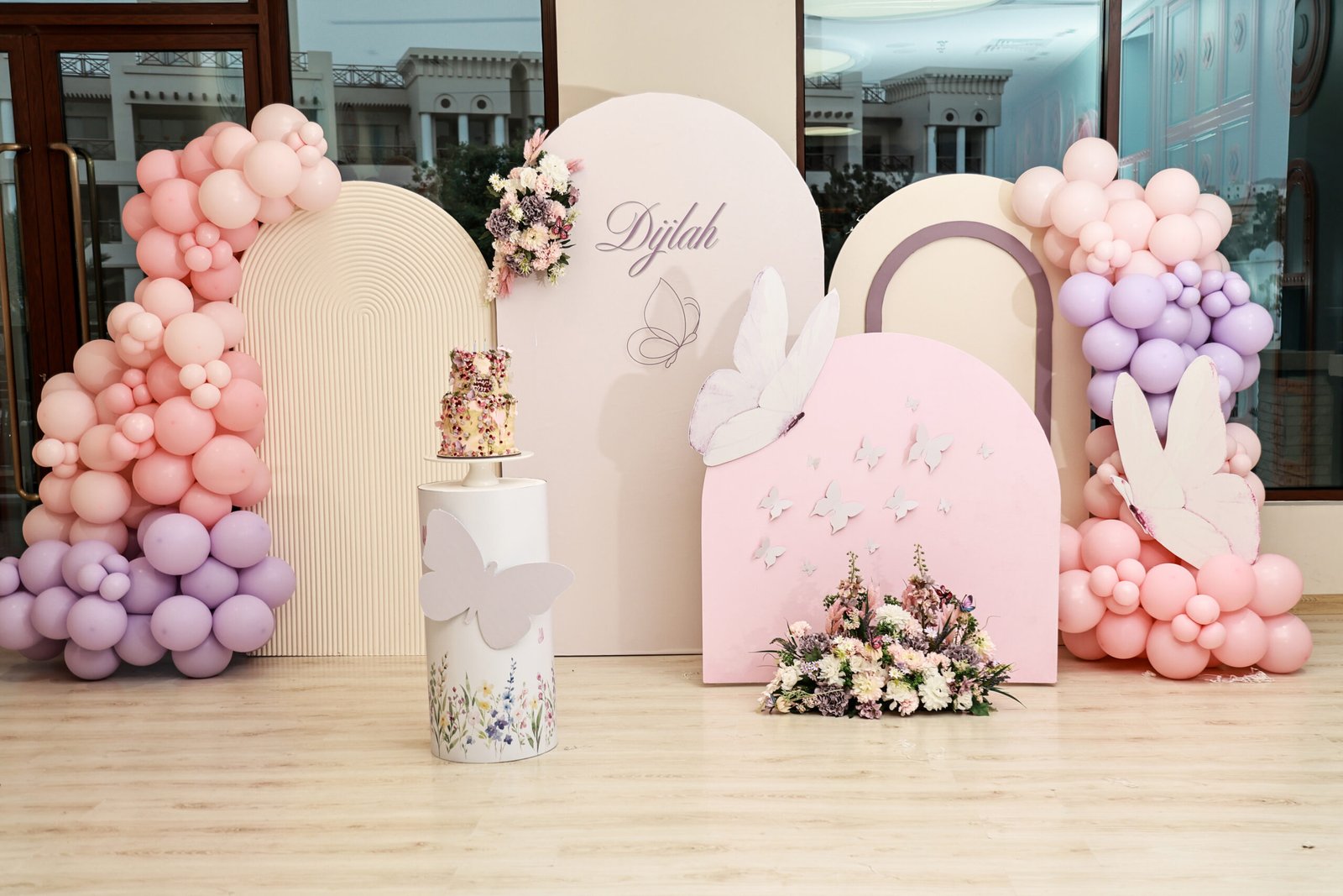 Pastel wings and flowers birthday setup