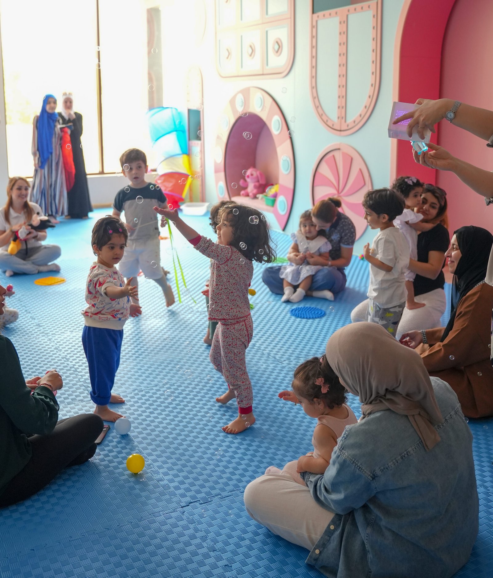 Adults and young children sharing a bubble activity