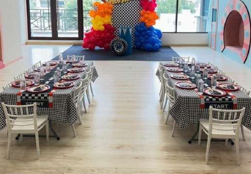 Plastic chairs, folding table and multicolour tablecloth